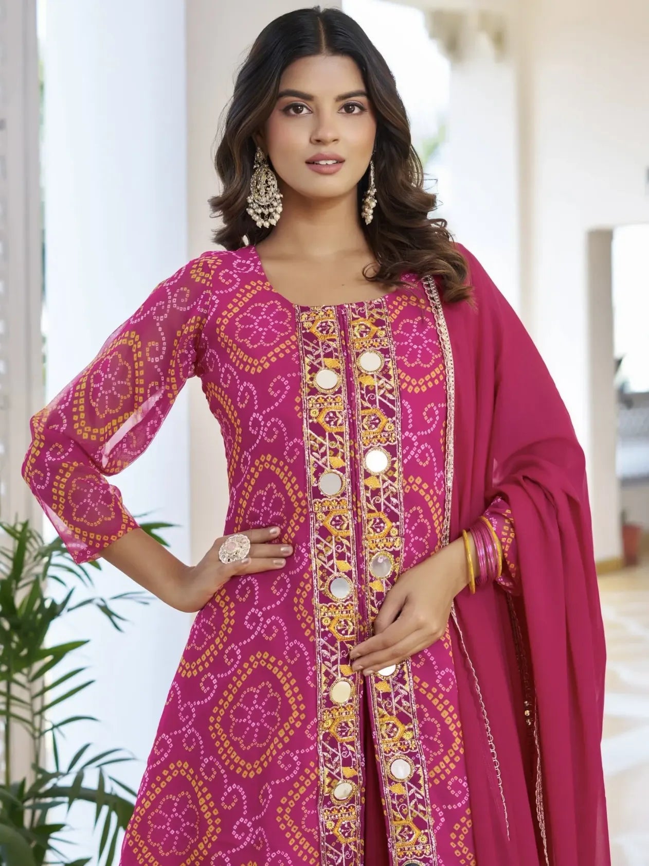 Woman wearing a pink embroidered traditional outfit with a blurred background