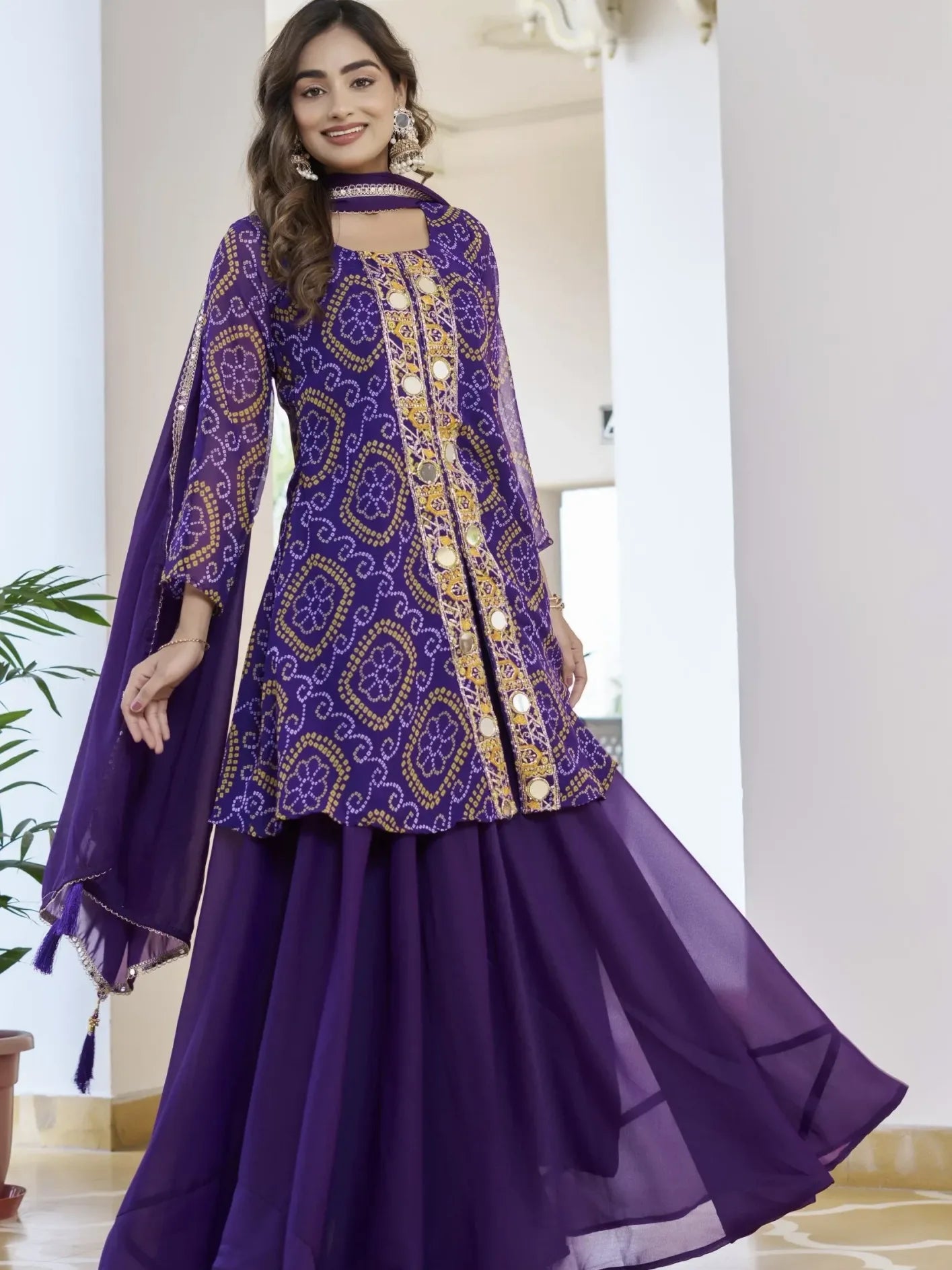 Woman wearing a purple and gold traditional outfit in an indoor setting