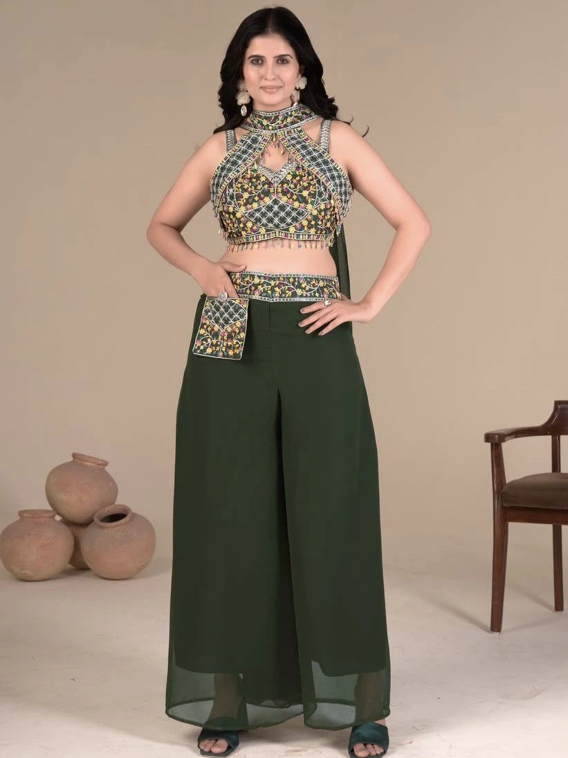 Woman wearing a traditional outfit with a green skirt and patterned top against a neutral background.