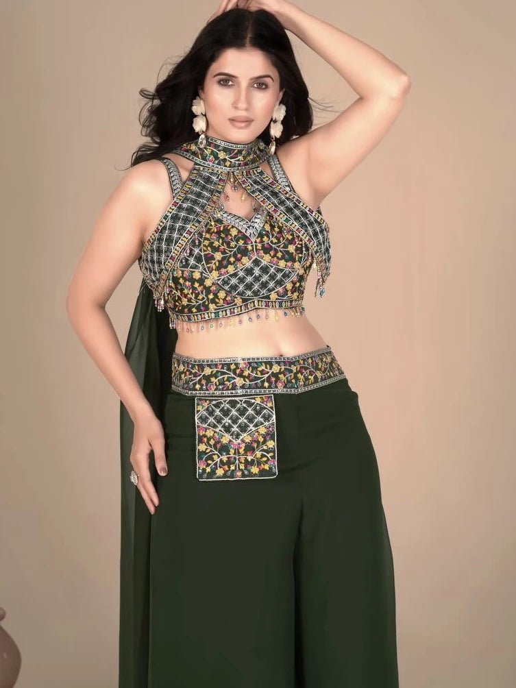 Woman wearing a traditional embroidered top and dark green pants against a beige background