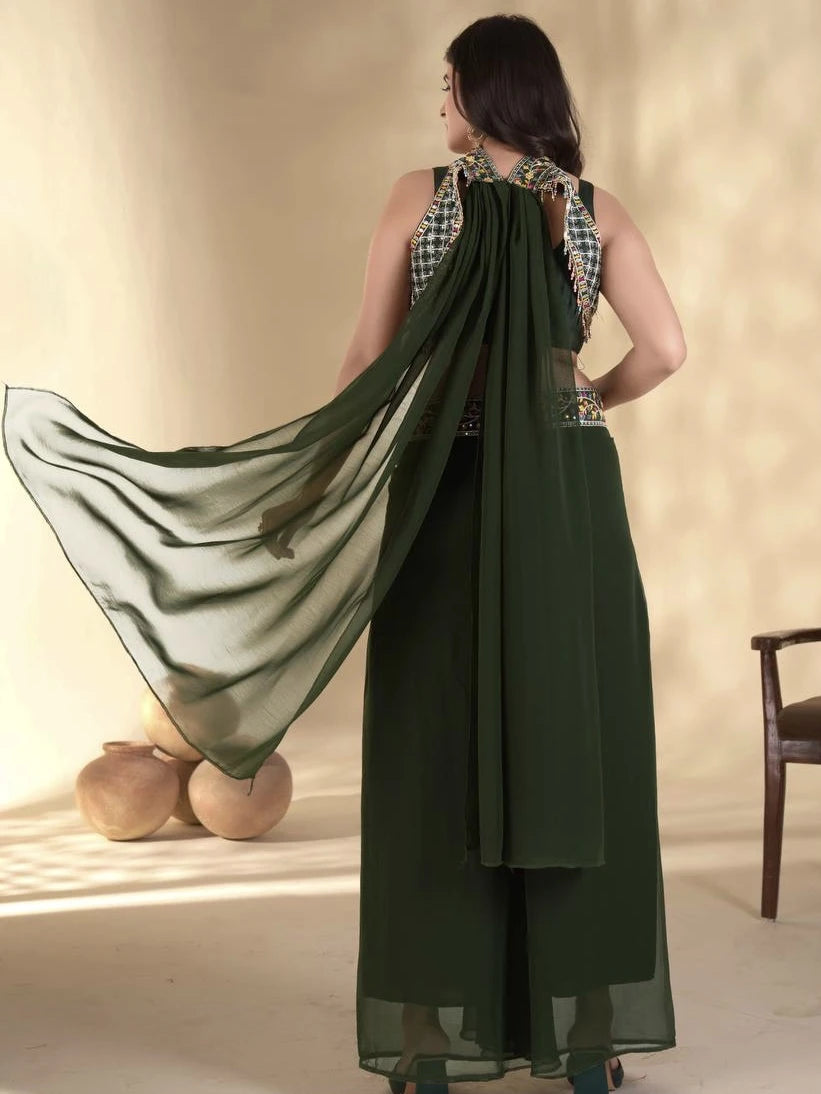 Woman wearing a green saree with a matching blouse against a beige background