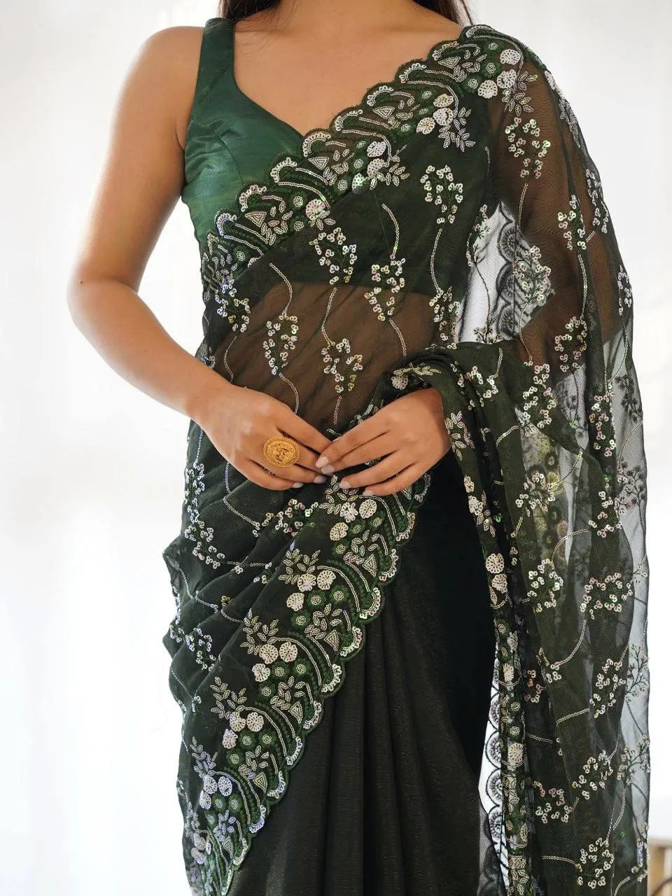 Green embroidered saree with a white background