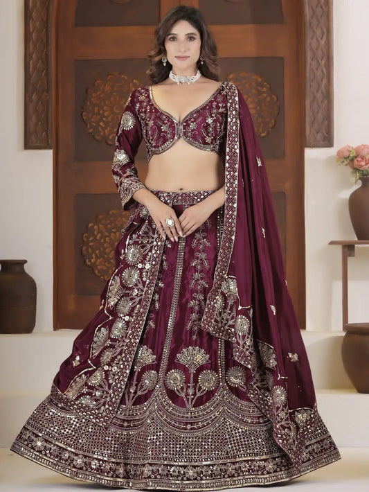Woman wearing a maroon embroidered traditional outfit with a wooden panel background
