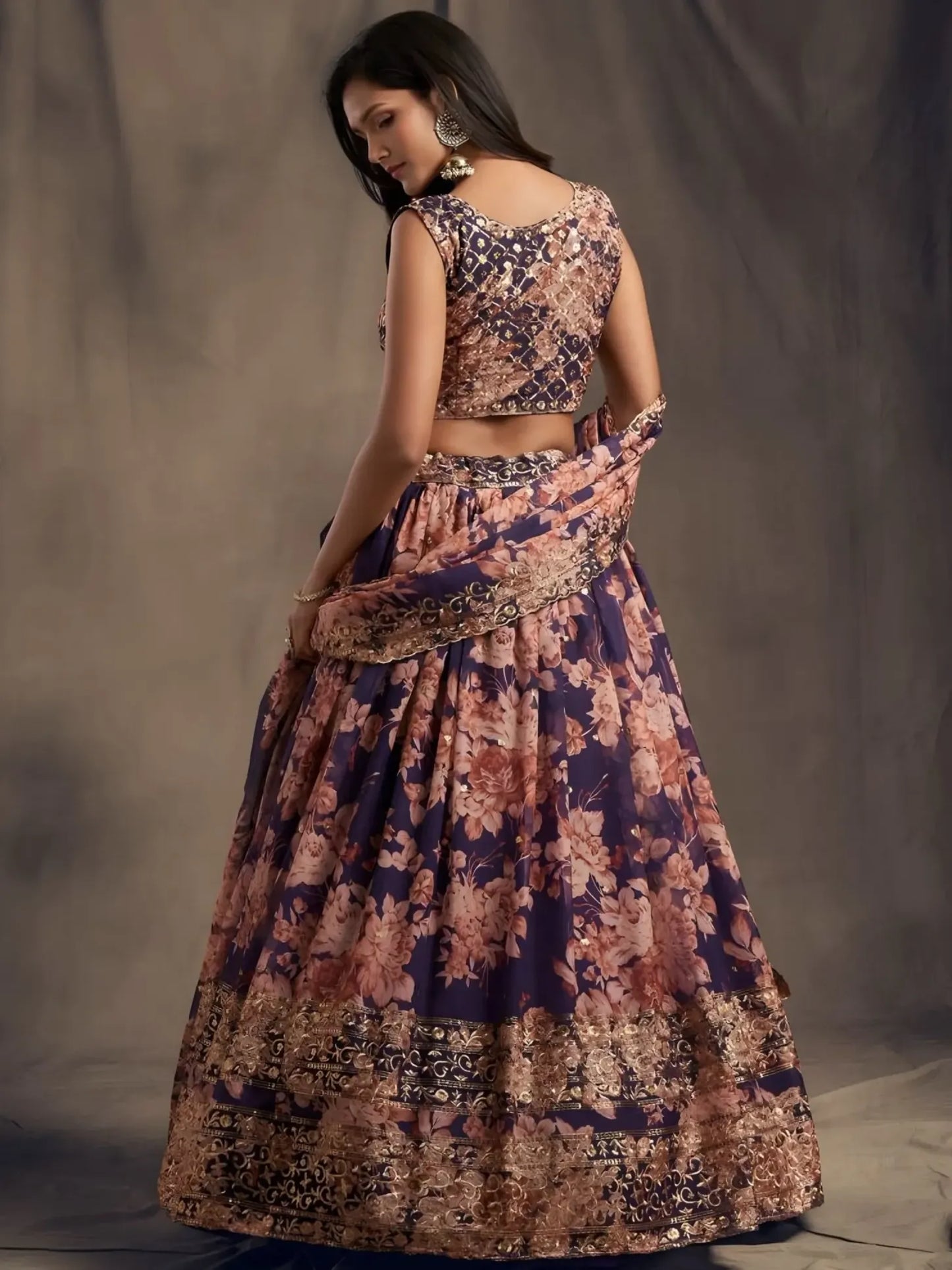 Woman wearing a floral two-piece outfit against a plain background