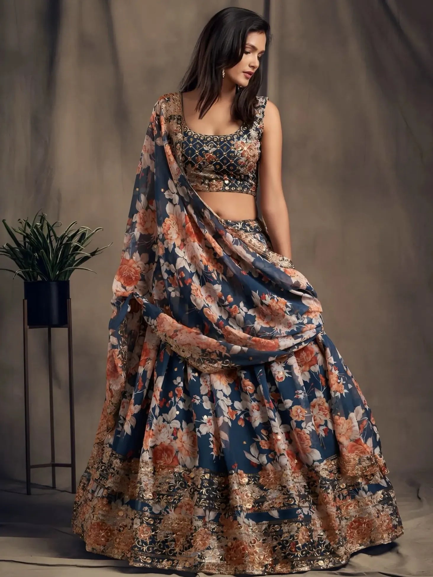 Woman wearing a floral lehenga with a plain background