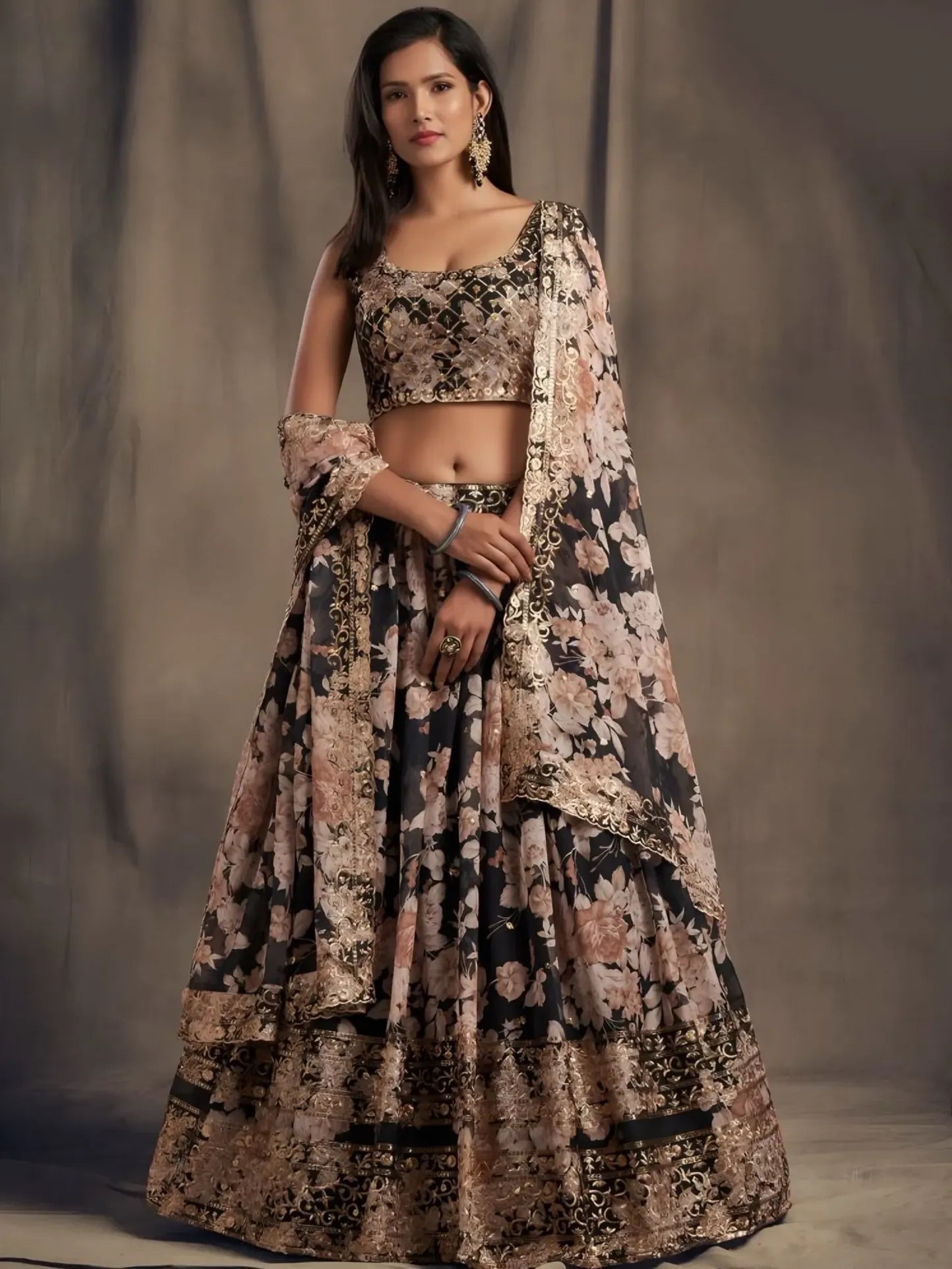 Woman wearing a floral lehenga with a plain background