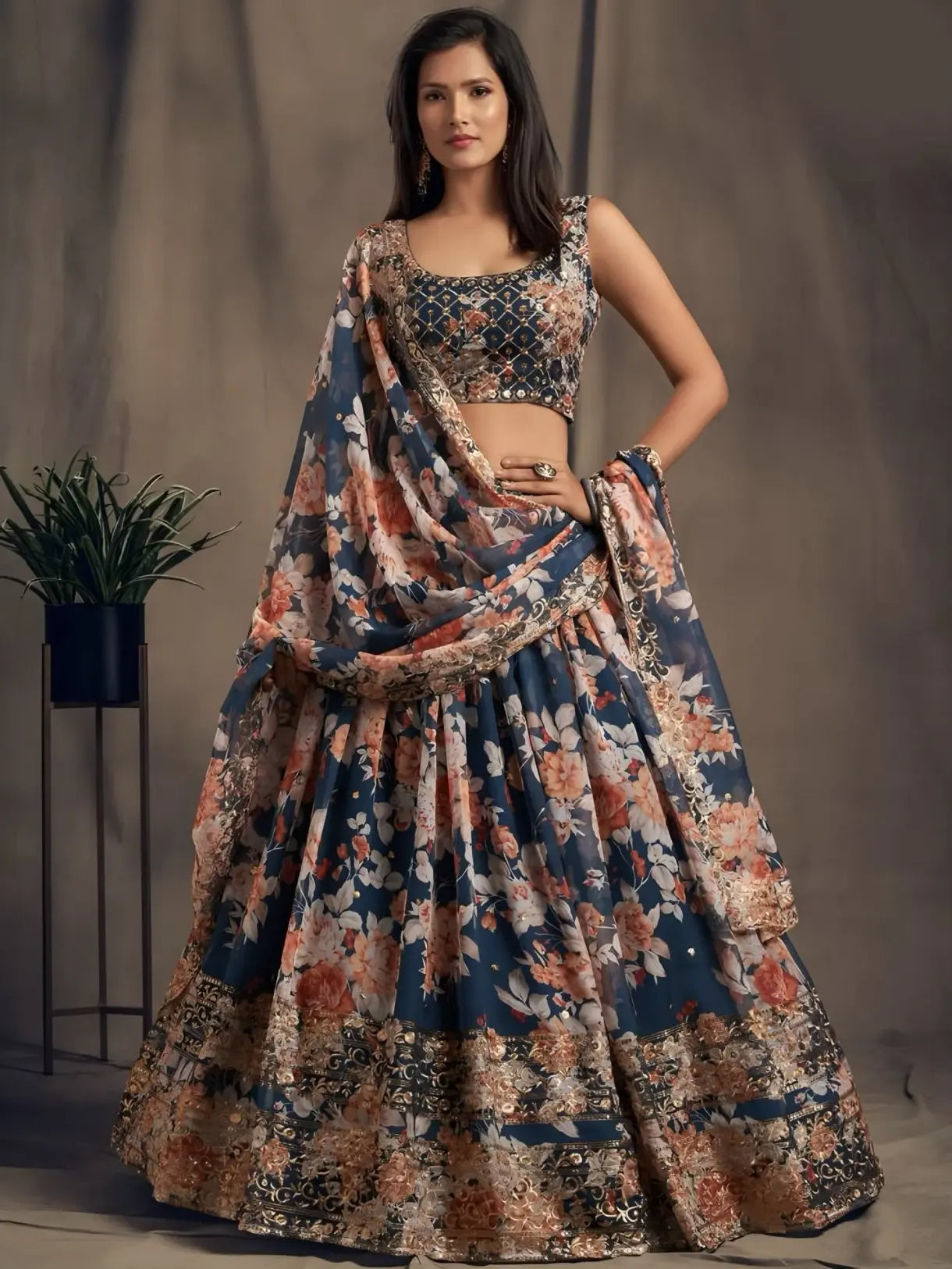 Woman wearing a floral lehenga with a matching dupatta against a neutral background