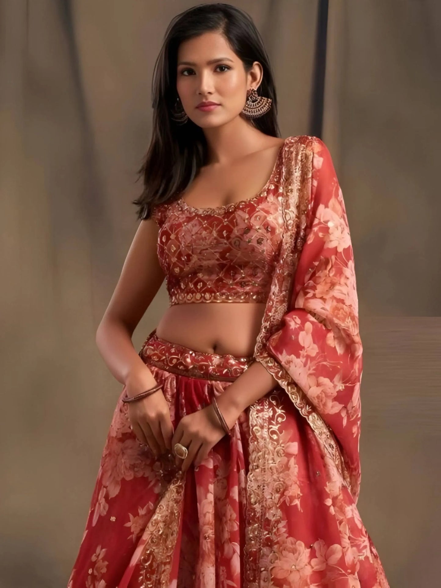 Woman wearing a red and gold traditional outfit with a floral pattern against a neutral background