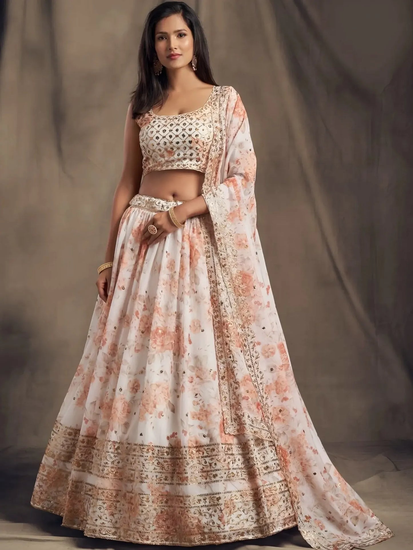 Woman wearing a traditional outfit with a floral design against a neutral background