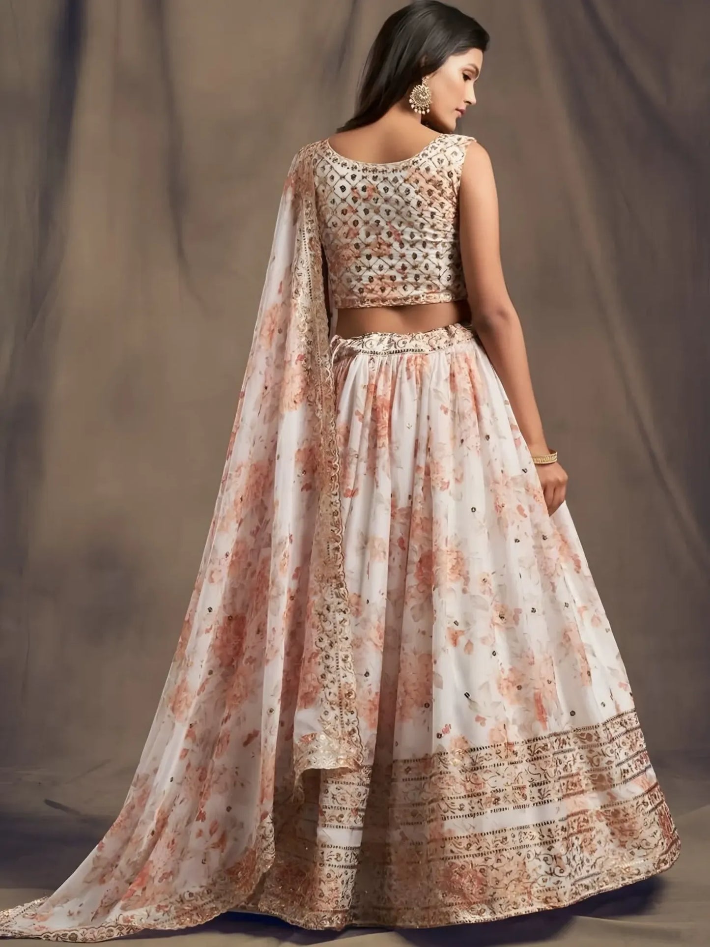 Woman wearing a floral lehenga with a plain background