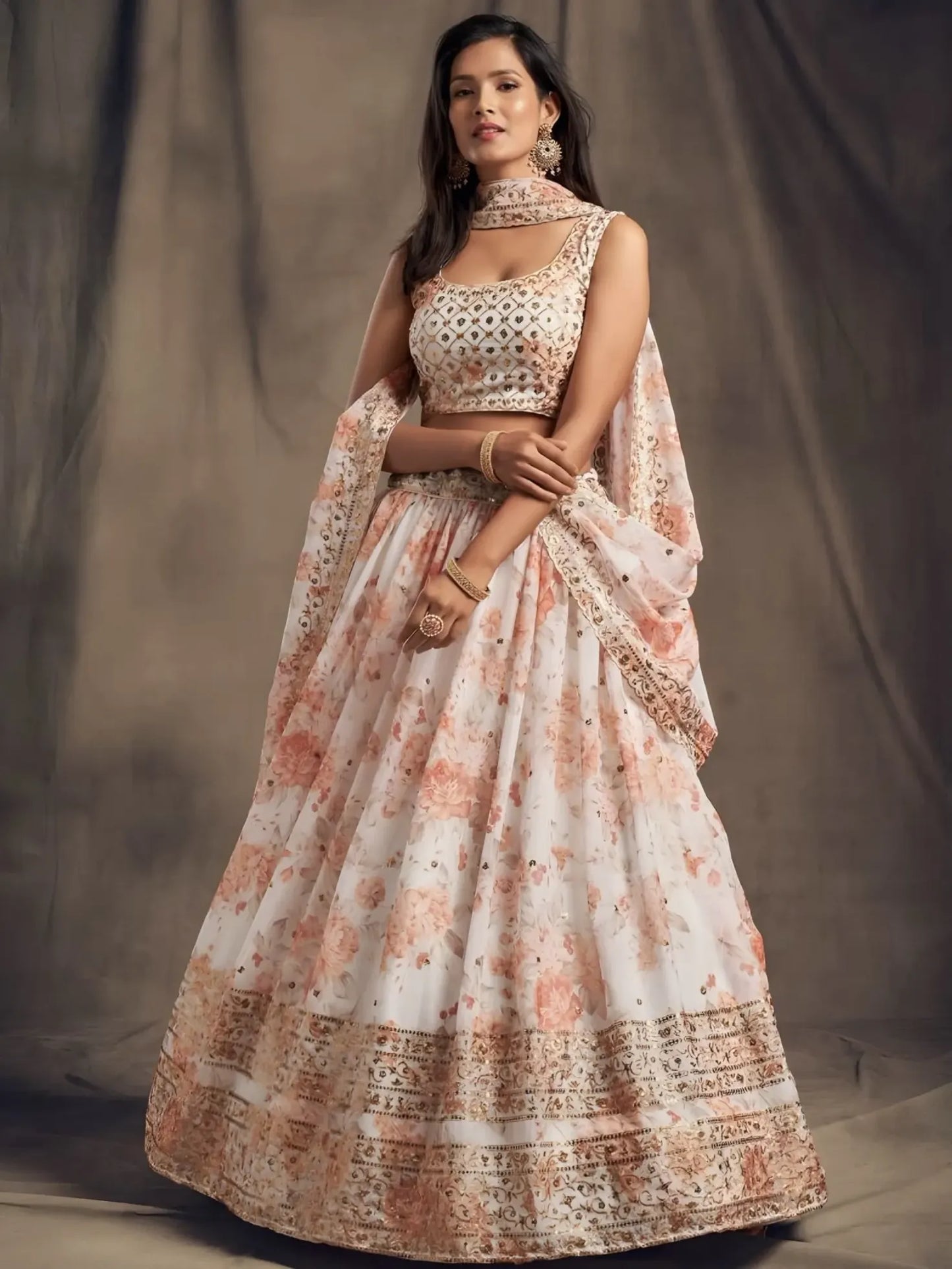 Woman wearing a traditional outfit with a floral design against a plain background