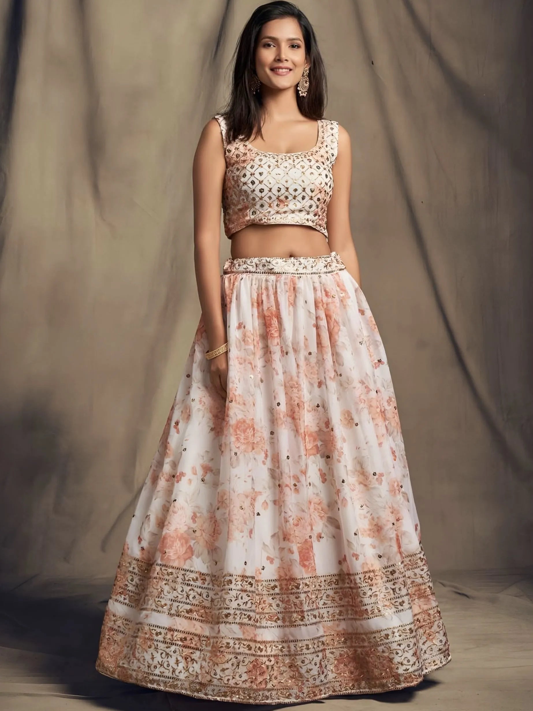 Woman wearing a traditional outfit with a floral pattern against a neutral background