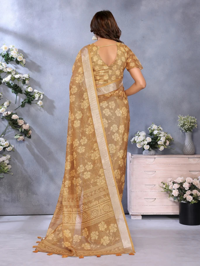 Woman wearing a gold saree with a floral background