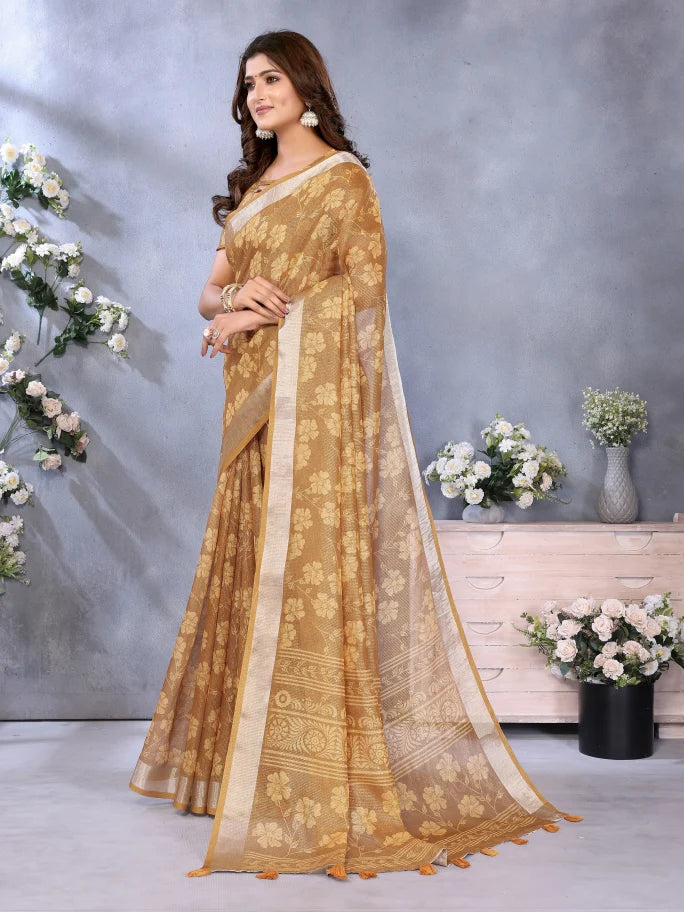 Woman wearing a gold saree with a floral background