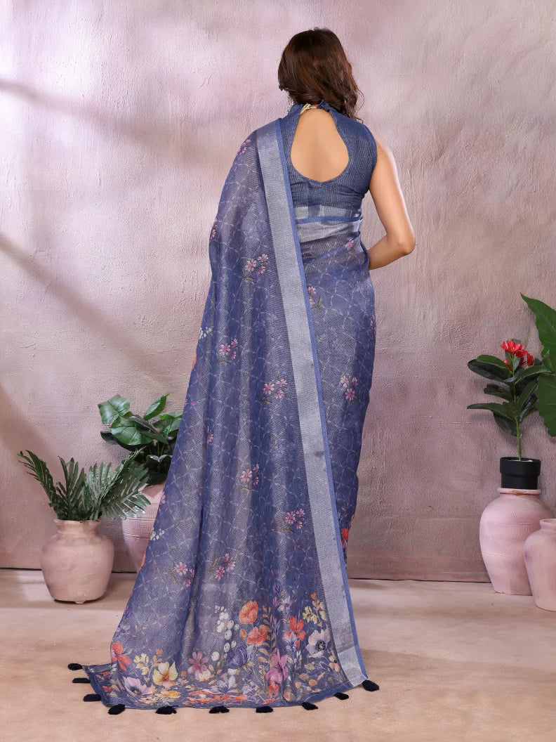 Woman wearing a blue floral saree with a plain background