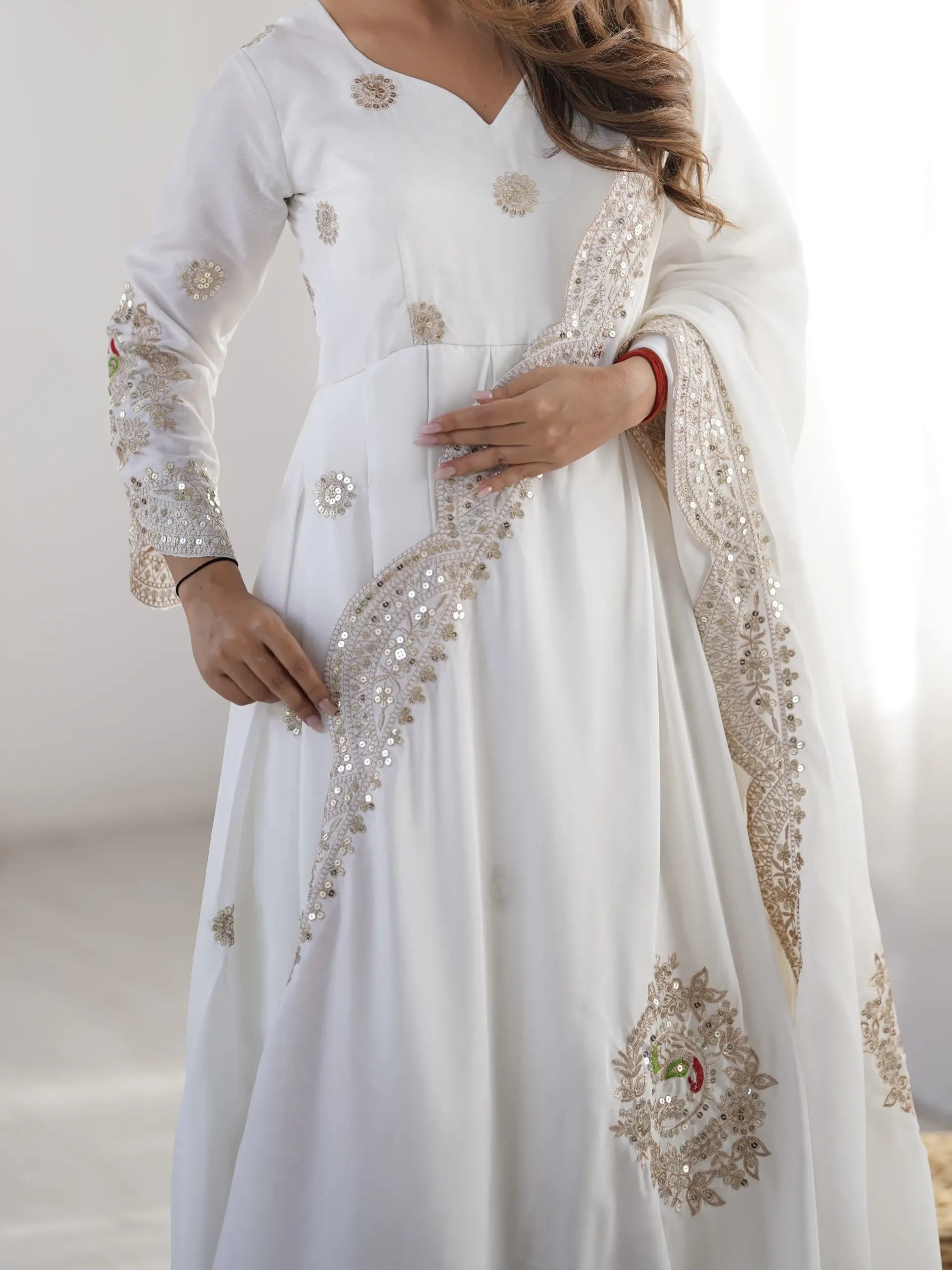 White embroidered traditional outfit with a plain background