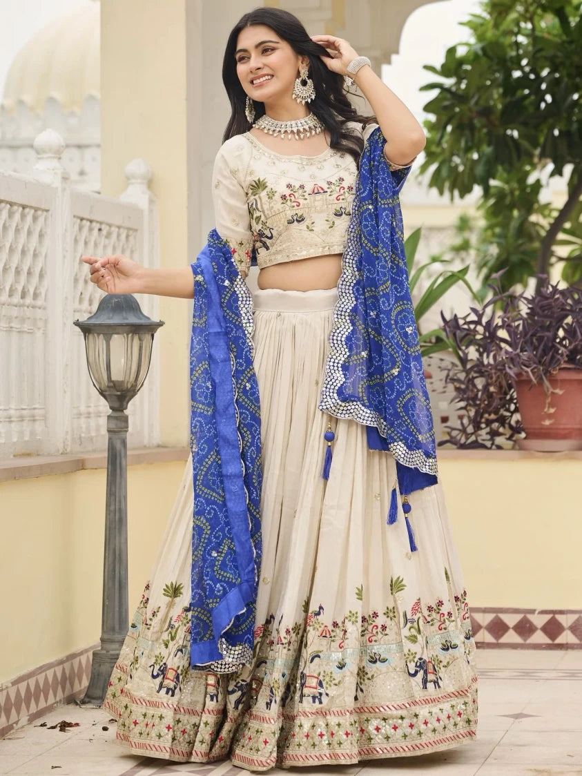 Woman in traditional outfit with blue dupatta in an outdoor setting