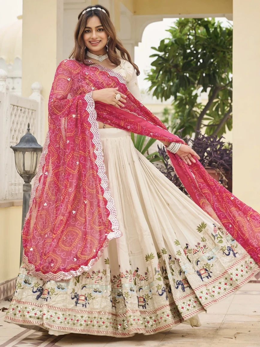 Woman wearing a traditional outfit with a pink dupatta in an outdoor setting