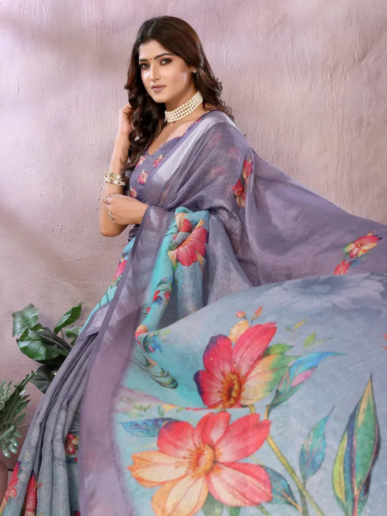 Woman wearing a floral saree with a plain background