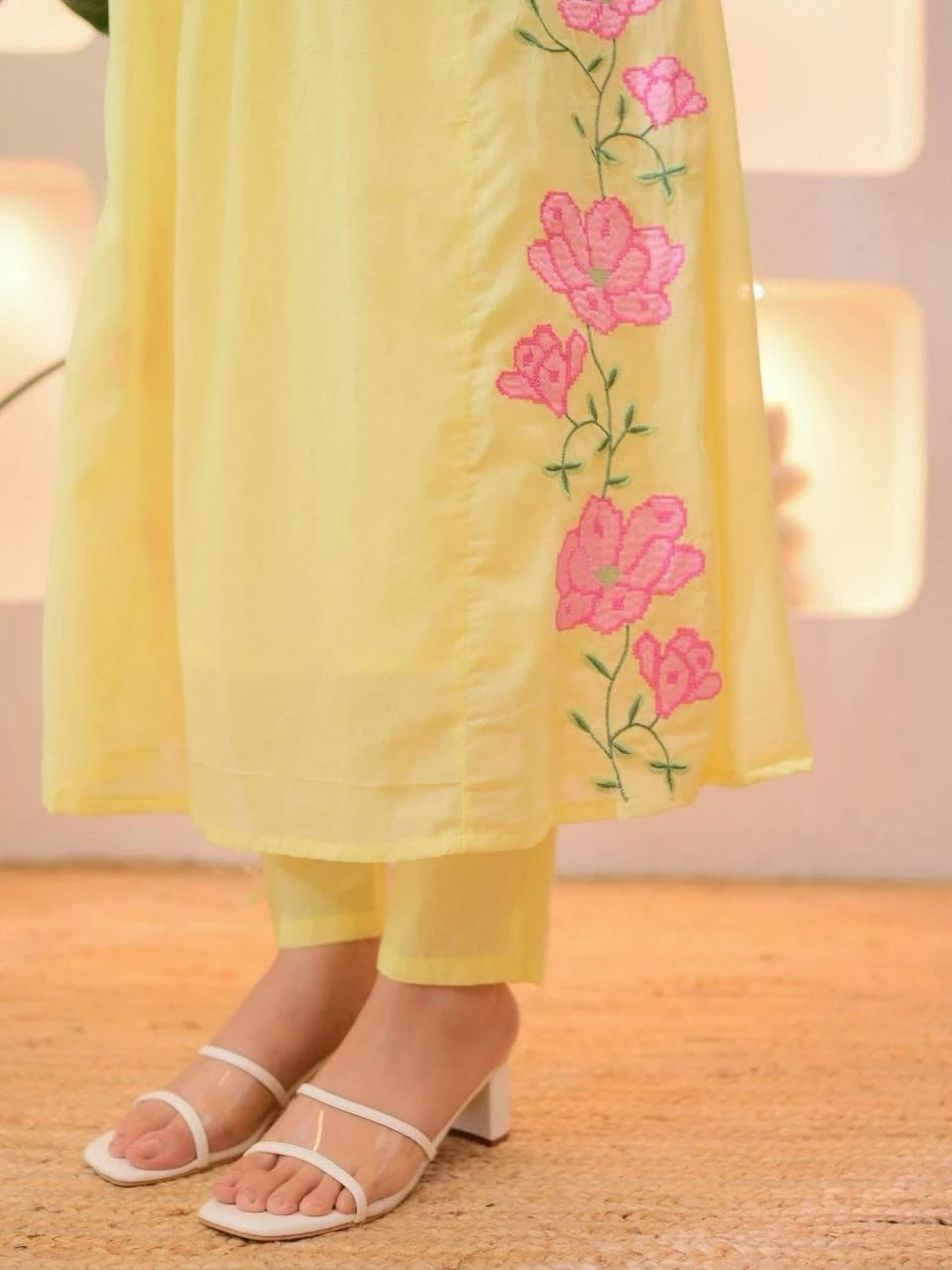 Yellow outfit with floral embroidery on a wooden floor