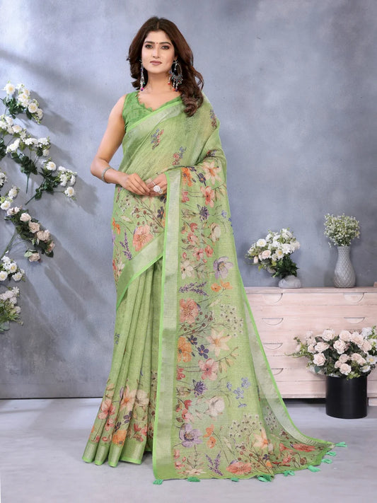 Woman wearing a light green saree with floral patterns against a gray background