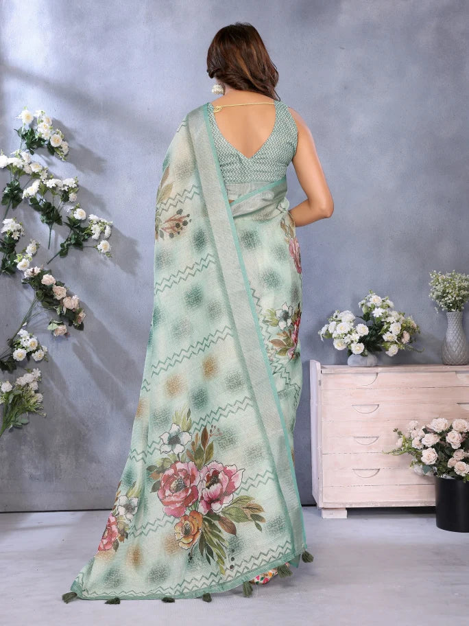 Woman wearing a floral saree with a gray wall and decorative flowers in the background