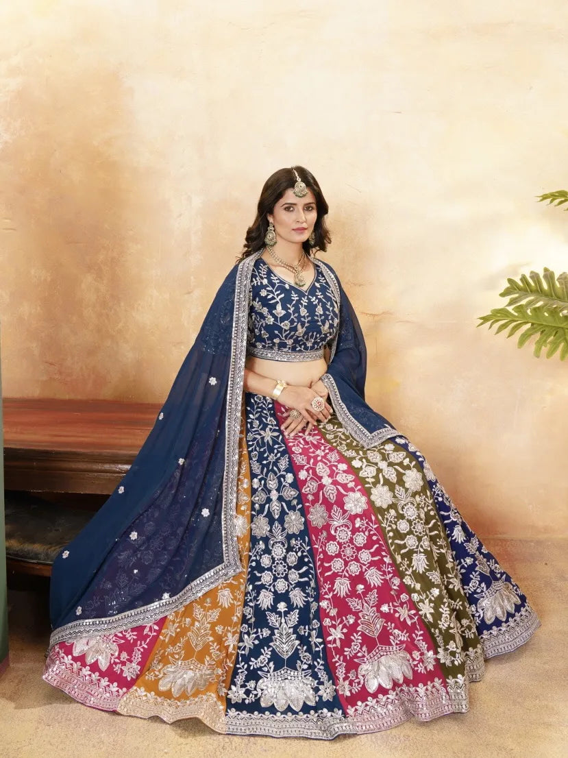 Woman wearing a traditional embroidered lehenga with a neutral background