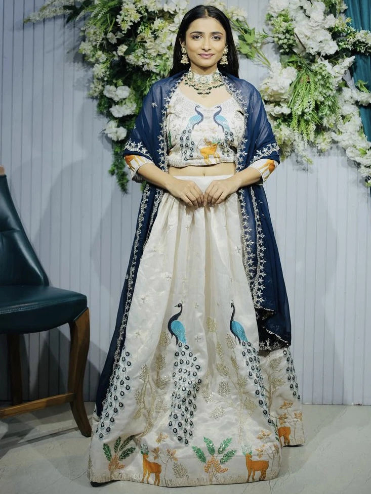 Woman in traditional outfit with floral decorations in the background
