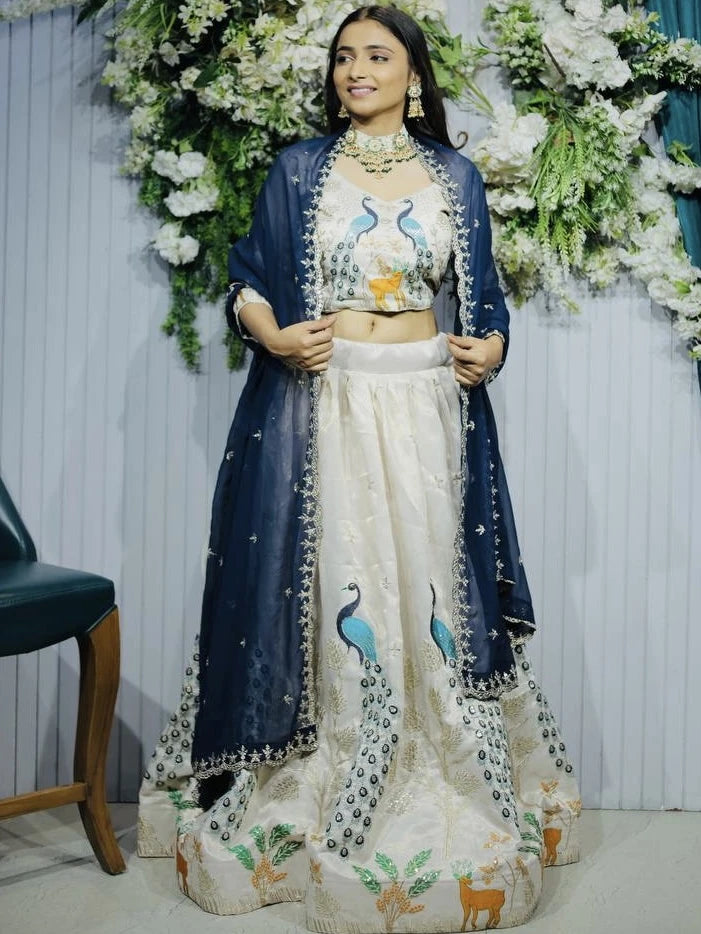 Woman in traditional outfit with floral decorations in the background