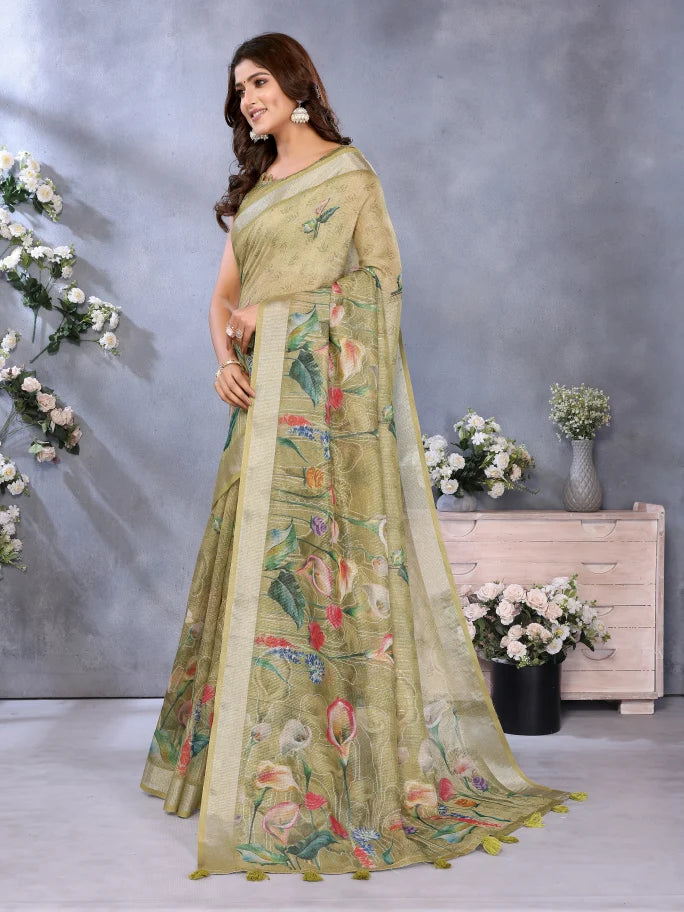 Woman wearing a green saree with floral patterns against a gray background