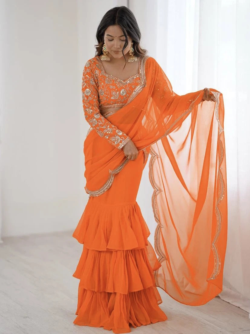 Woman wearing an orange saree with a white background