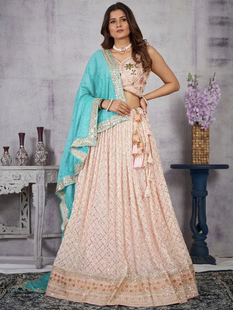 Woman wearing a traditional outfit with a blue dupatta in a decorative setting.