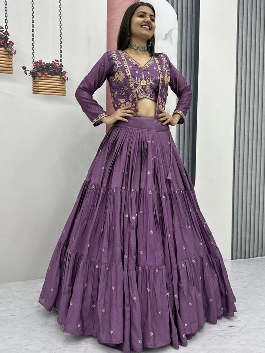 Woman wearing a purple traditional outfit with a matching skirt and blouse.