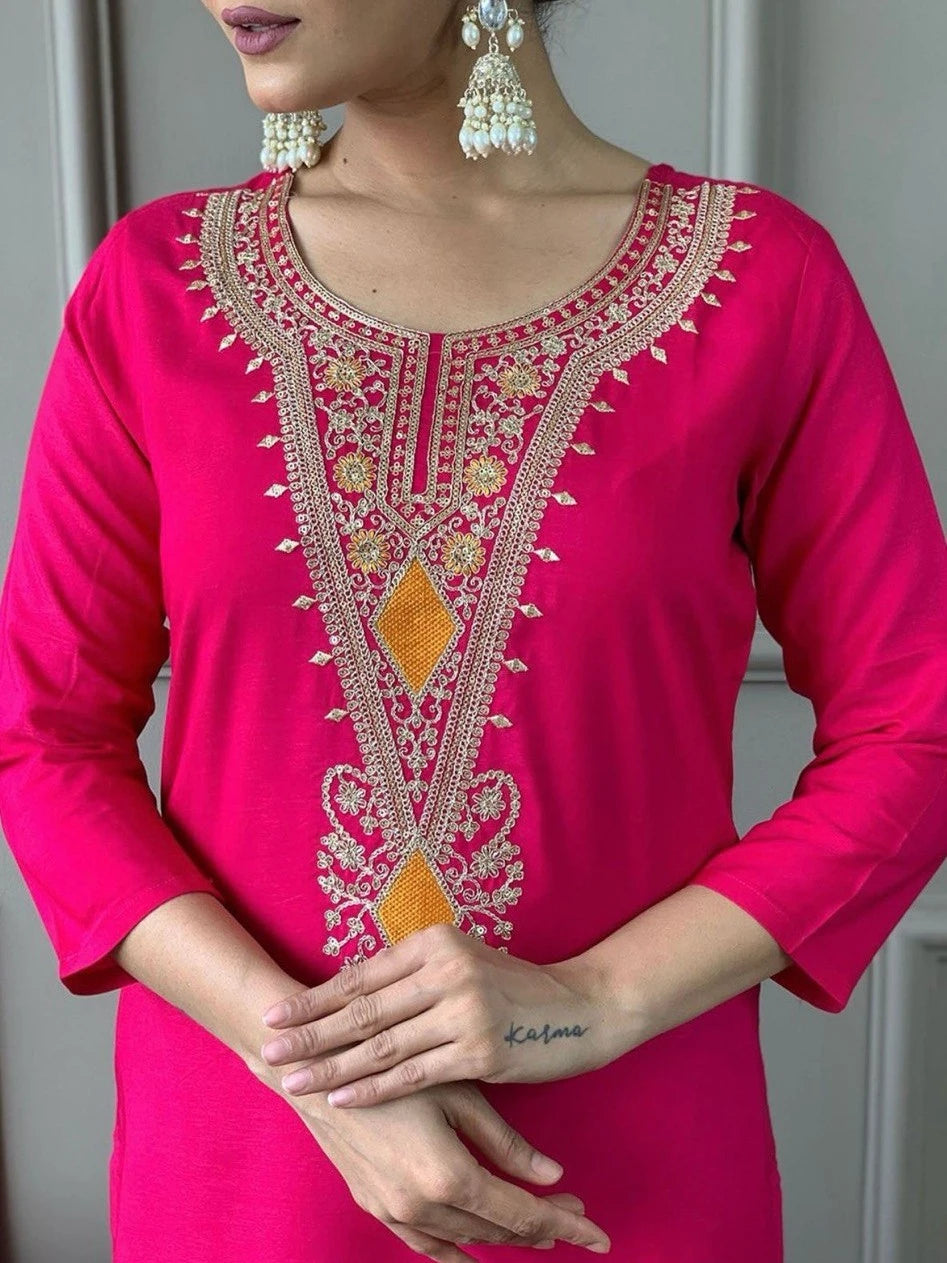 Pink embroidered kurta worn by a person, with a neutral background