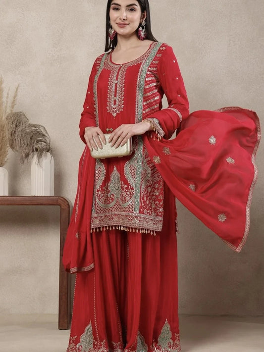 Red embroidered traditional outfit with a matching dupatta on a neutral background