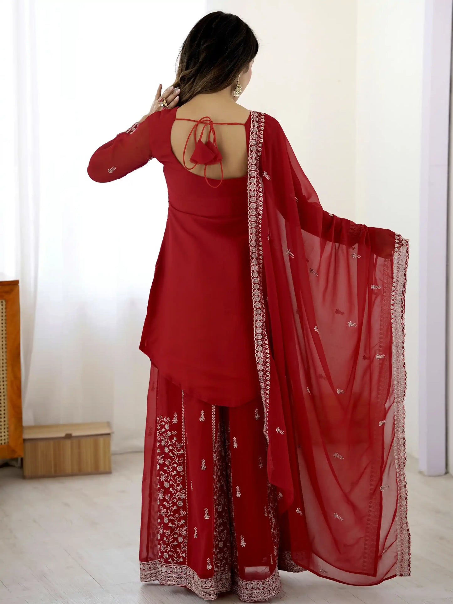 Red traditional outfit with a matching dupatta on a white background