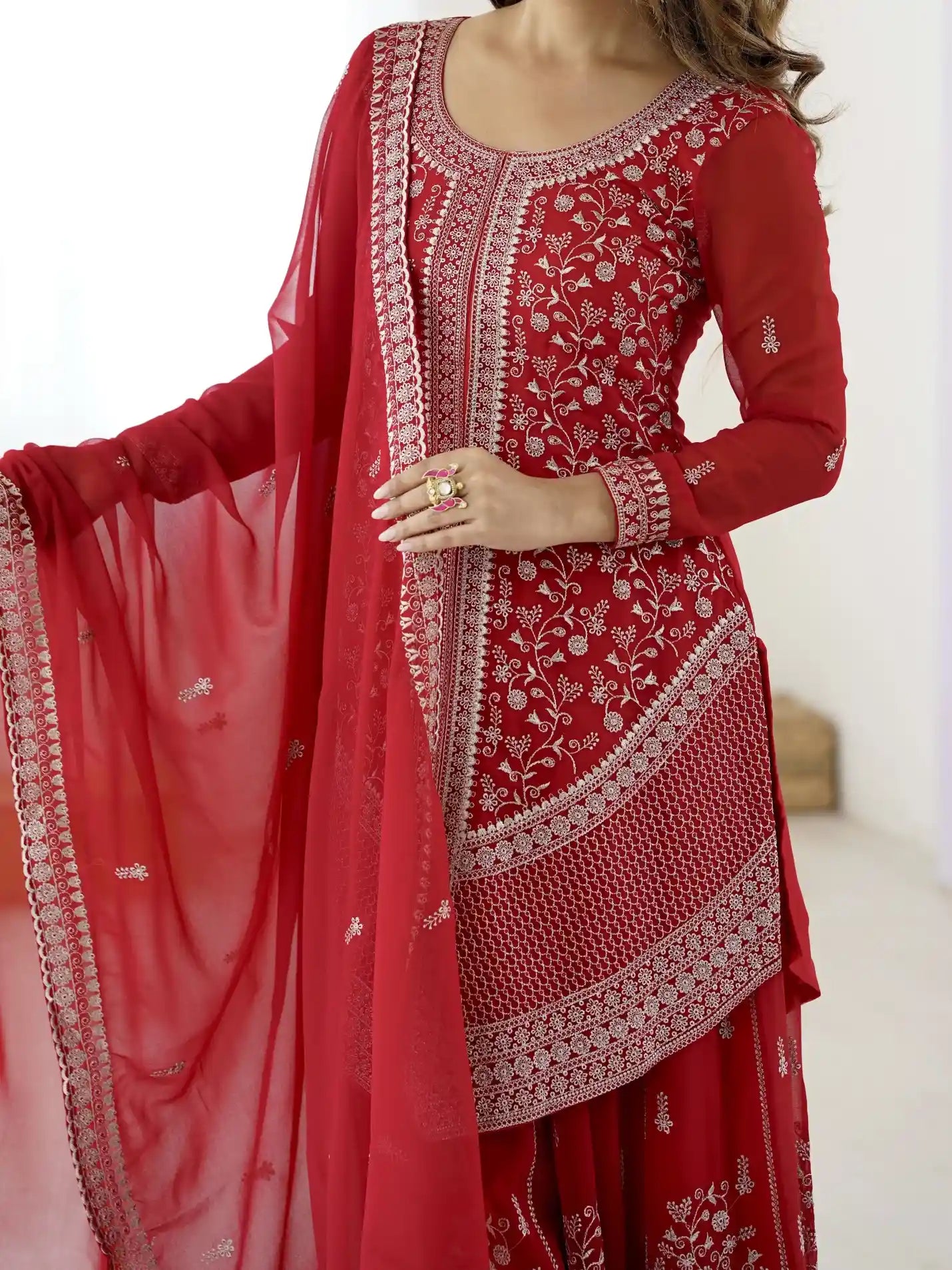 Red embroidered traditional outfit with a white background