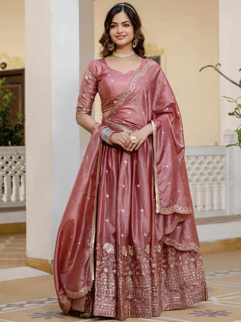 Woman wearing a traditional pink saree with a white background
