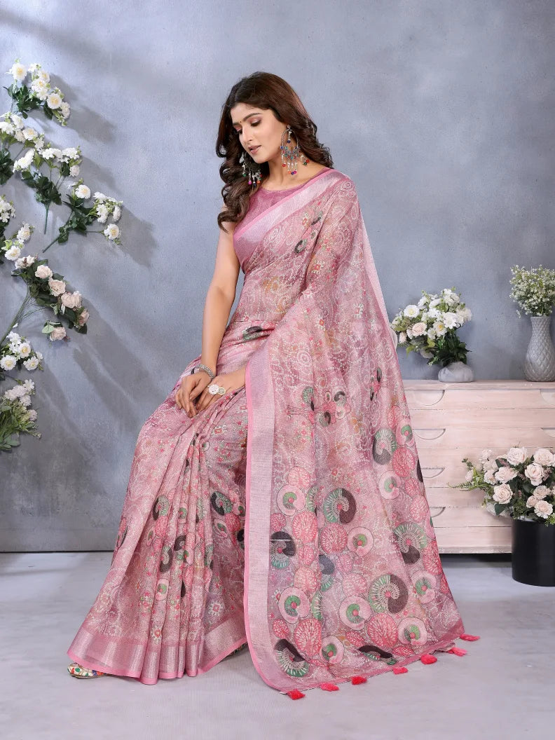 Woman wearing a pink saree with a floral background