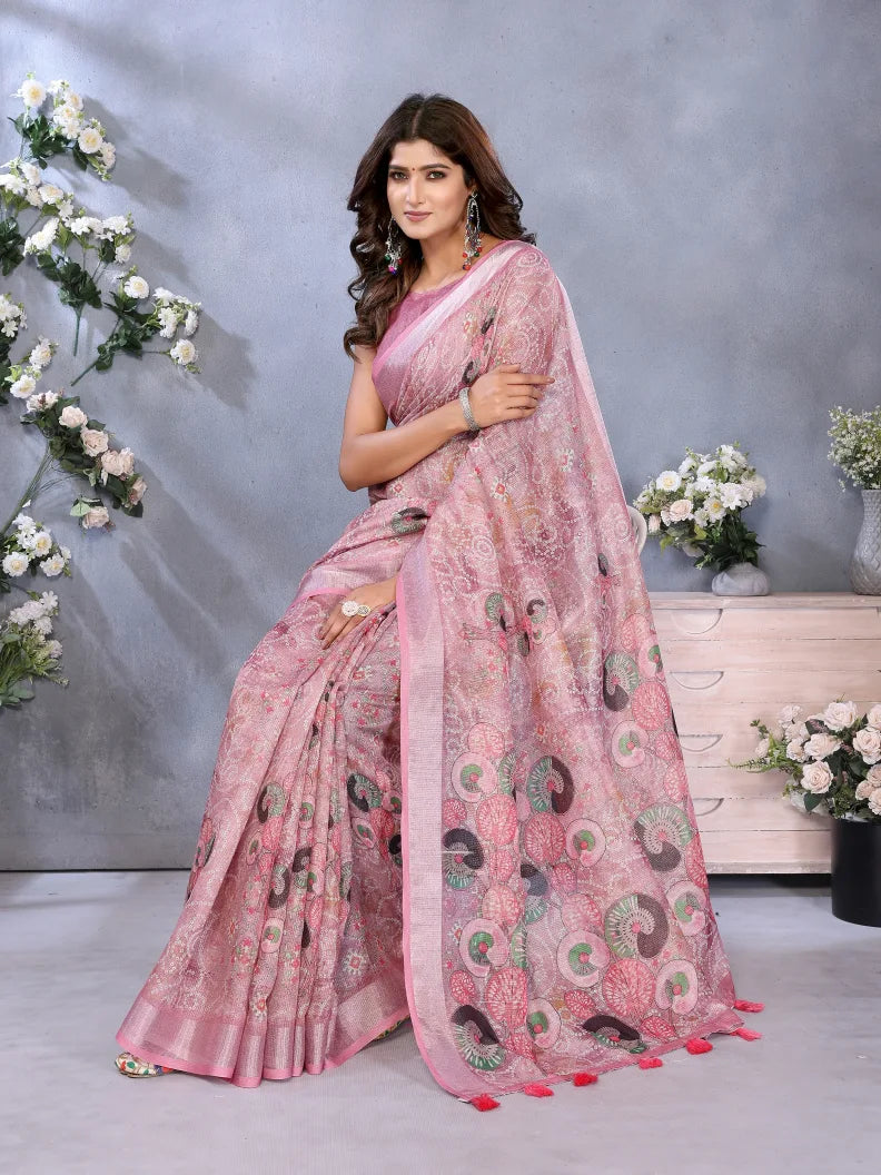 Woman wearing a pink saree with a floral background