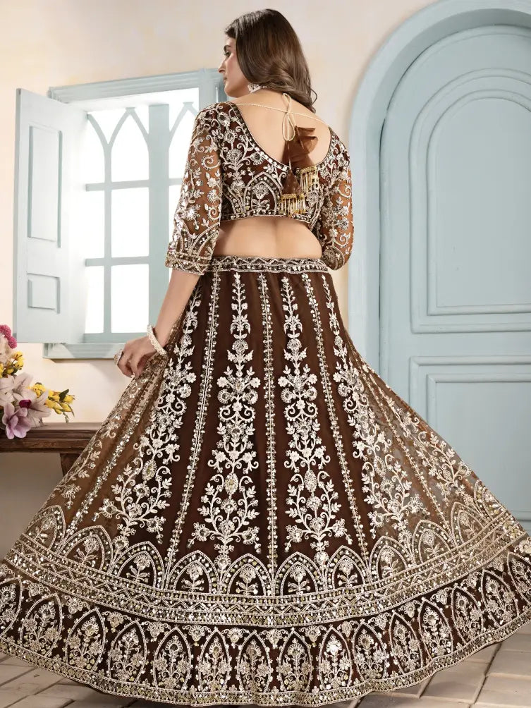 Woman wearing a brown and white embroidered traditional outfit with a light blue door in the background.
