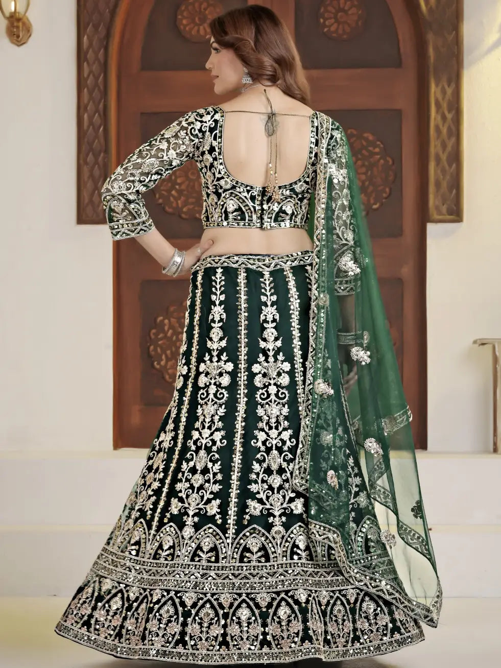 Traditional black and white embroidered lehenga with green dupatta against a neutral background