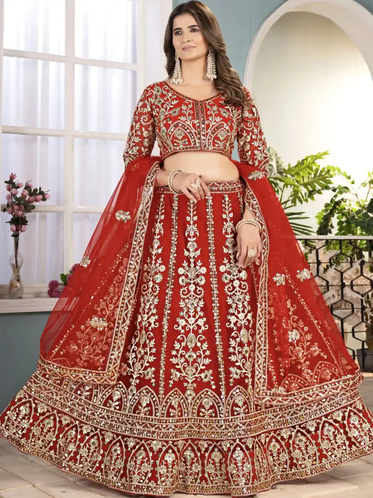 Red embroidered traditional outfit with white patterns on a neutral background