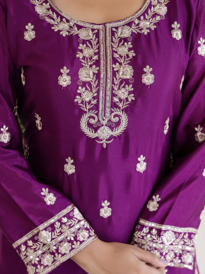 Purple embroidered garment with intricate white patterns
