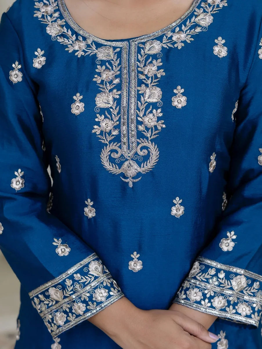Blue embroidered garment with intricate silver patterns