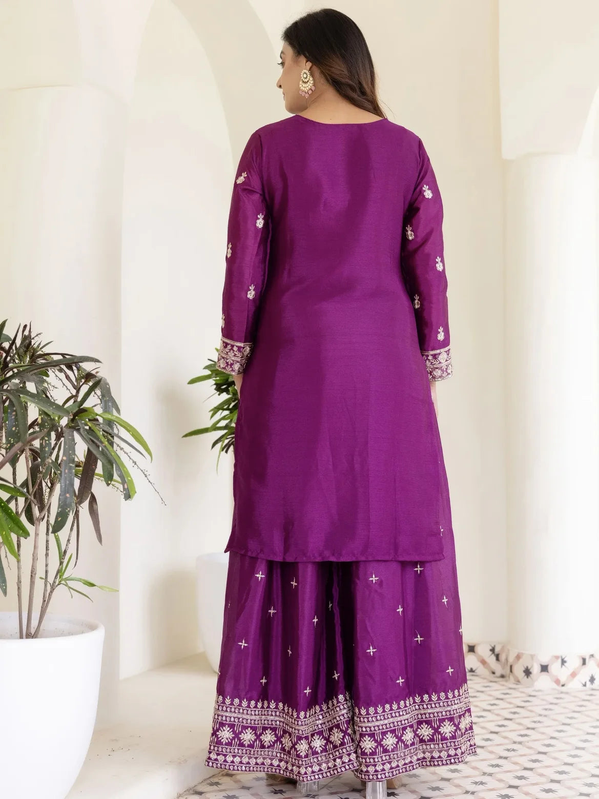 Purple traditional outfit with white patterns on a white background
