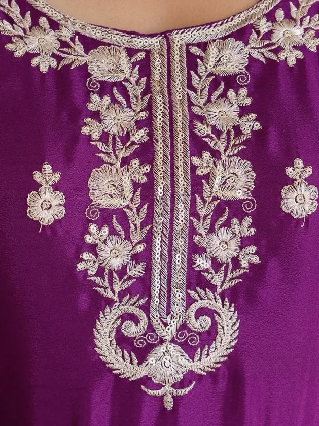 Purple fabric with intricate white floral embroidery