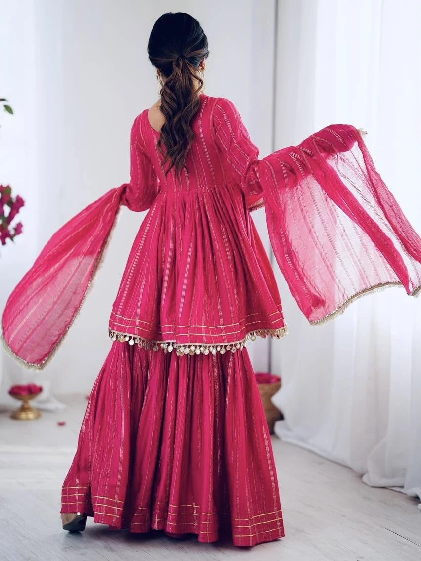 Pink traditional outfit with long sleeves and a flowing skirt on a white background