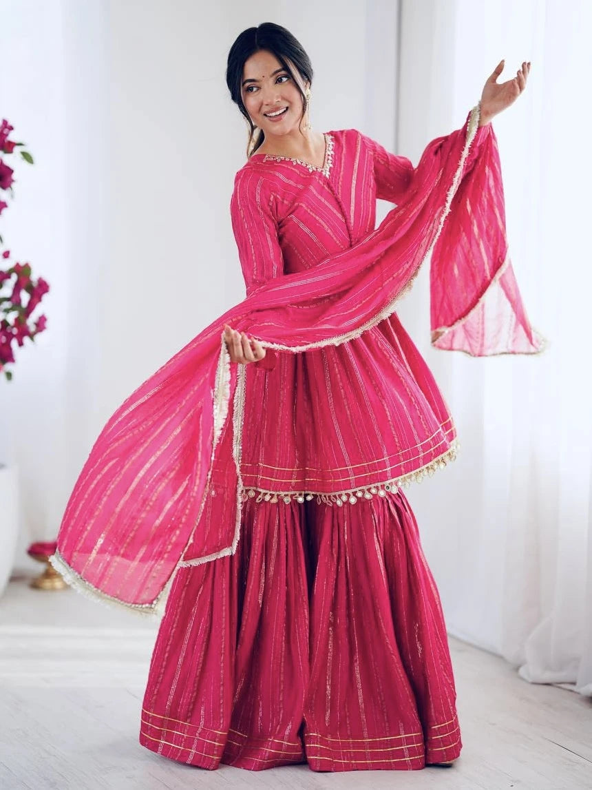 Woman in a traditional pink outfit with a white background