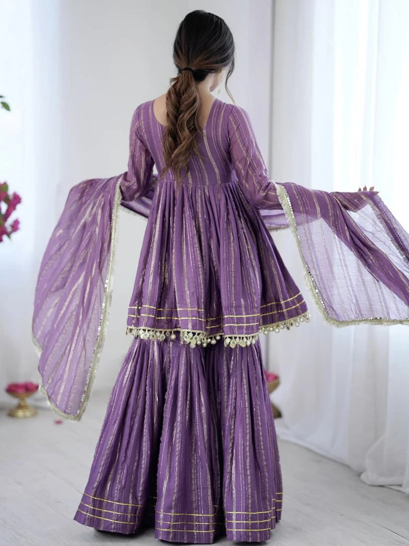 Woman wearing a traditional purple outfit with a white background